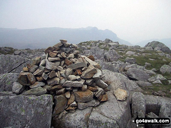 Rossett Pike summit cairn with The Langdale Pikes in the distance