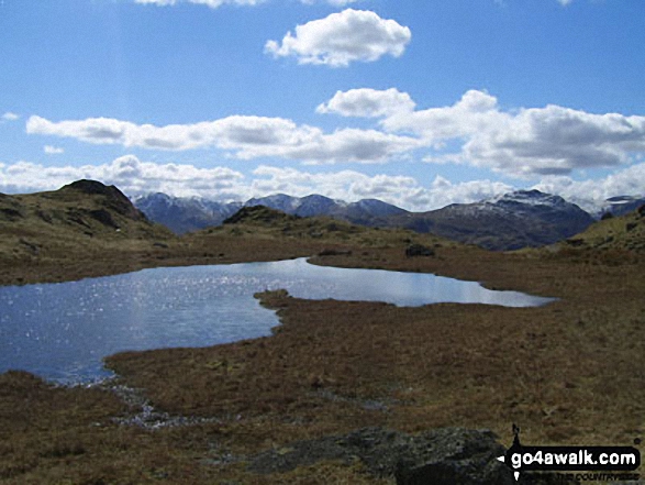 Looking across an unnamed tarn below Great Castle How to Wetherlam and the Furness Fells