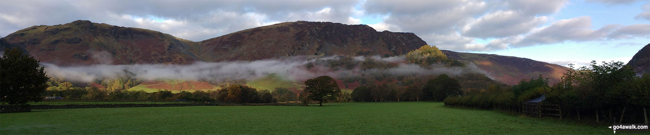 Walk c139 Allen Crags, Glaramara and Seathwaite Fell from Seatoller - Early morning valley mist below Dale Head (Newlands) and High Spy, Maiden Moor & Cat Bells (Catbells) with the summit of Castle Crag (front right) lit by a ray of sunshine from Rosthwaite