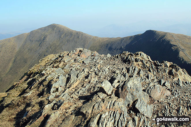 The rocky summit of Hopegill Head with Hobcarton Crag and Grisedale Pike beyond