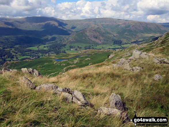 Looking down to Alcock Tarn from near Heron Pike with Helm Crag, Gibson Knott and Steel Fell beyond