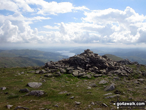 The summit cairn on Fairfield with Windermere in the distance