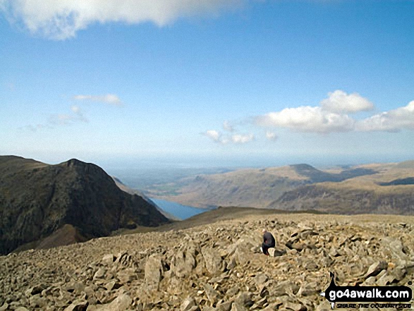 Walk c111 Scafell Pike from Wasdale Head, Wast Water - Lone fell walker on Scafell Pike with Symonds Knott and Sca Fell (left), Wast Water and Seatallen (right) beyond