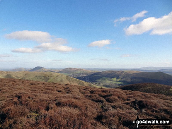 The Lawley (left), Caer Caradoc Hill, Church Stretton, Ragleth Hill (right) with Yearlet and Ashlet  in the mid-distance from near Grindle above Ashes Hollow