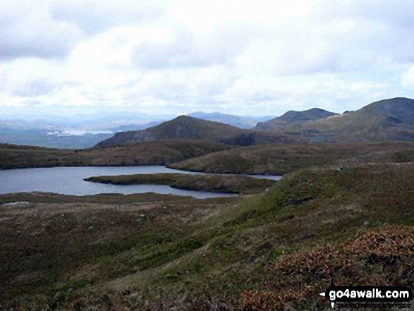 Walk cw115 Allt-fawr, Moel Druman and Ysgafell Wen from Crimea Pass (Bwlch y Gorddinan) - LLyn Coch with Porthmadog in the distance from the approach to Ysgafwell Wen