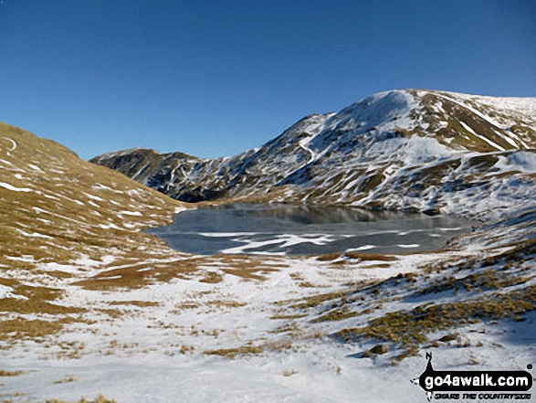 Walk c269 The Grisedale Horseshoe from Patterdale - Grisedale Tarn in the snow with St Sunday Crag (centre left) and Fairfield (right)