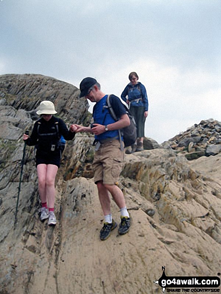 Walk gw100 Mount Snowdon (Yr Wyddfa) from Pen-y-Pass - Andy and Nell negotiating a tricky section of the PYG Track up Mount Snowdon. Tess waits her turn.