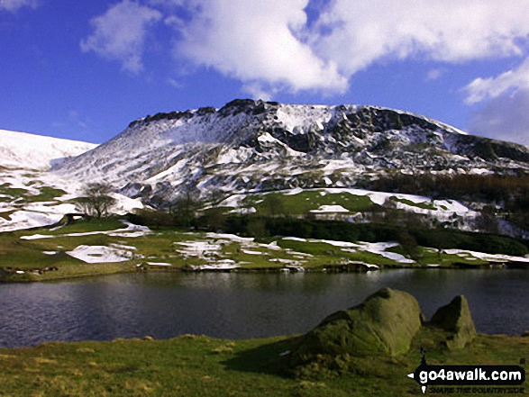 Walk gm150 Great Dove Stone Rocks Stable Stones Brow (Hoarstone Edge) from Dove Stone Reservoir, Greenfield - Dove Stone Reservoir with snow on Great Dove Stone Rocks beyond