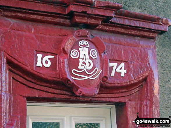 The date 1674 carved into a door frame in Askham village