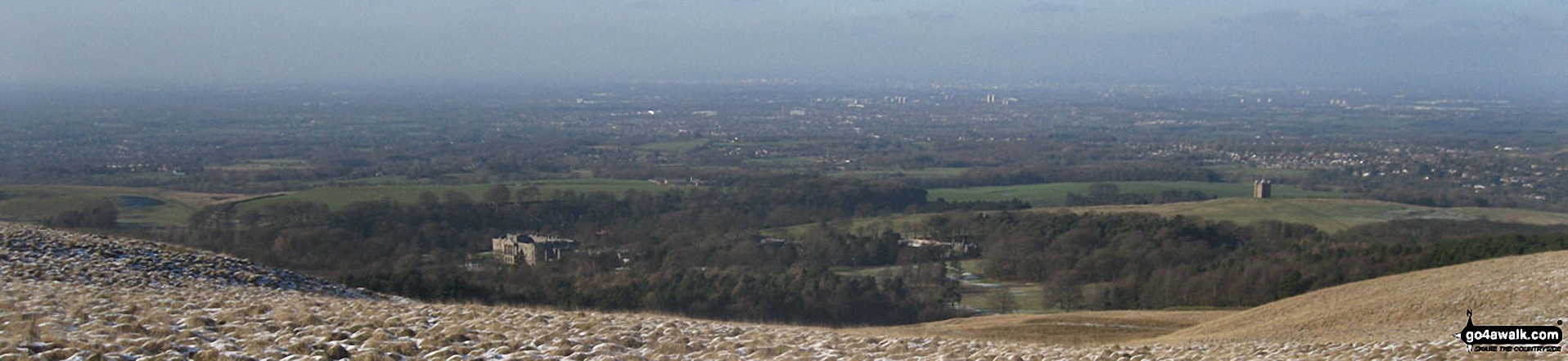 Lyme Hall (left) and The Cage (right) with Manchester and Stockport beyond from the memorial in Lyme Park Country Park just north of Bowstonegate Farm