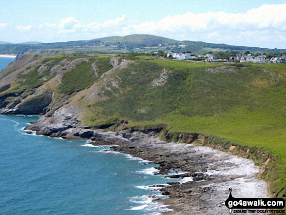 Mitchin Hole Cave, Bacon Hole and Deep Slade with Penmaen rising in the distance from Pwlldu Head