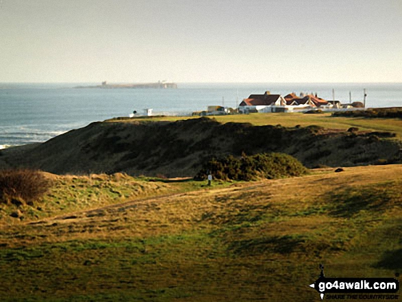 Farne Islands beyond The Club House for Bamburgh Golf Course from Budle Point