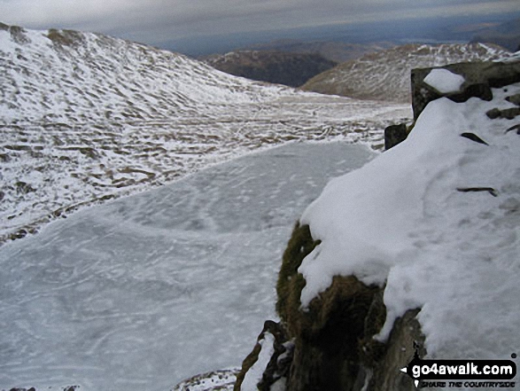 Walk c427 Helvellyn via Striding Edge from Patterdale - A Frozen Red Tarn from Striding Edge in the Snow