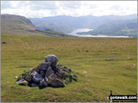 Heughscar Hill summit cairn with Ullswater in the distance