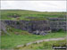 An old quarry with Faulds Brow summit on the horizon