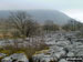 Ingleborough in mist beyond Limestone Pavement in Chapel-le-Dale